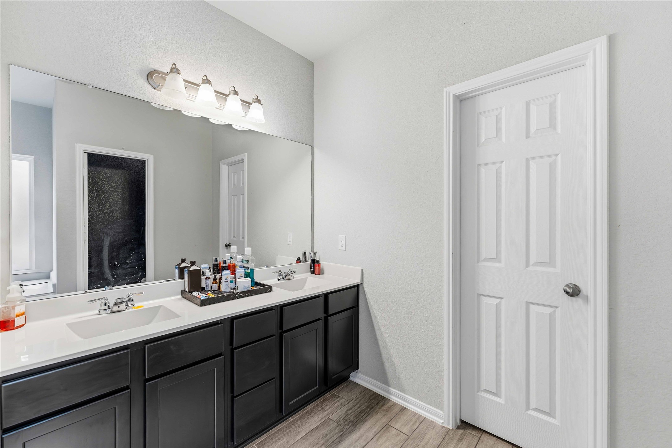 14810 Ruddy Duck Lane Houston, TX 77049 - Photo 23 of 28 a bathroom with a double vanity sink and a mirror