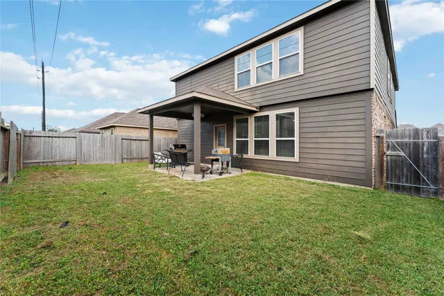 a backyard of a house with table and chairs