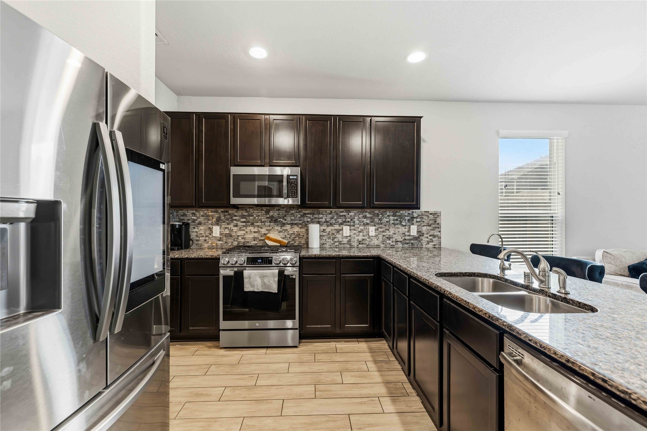 14810 Ruddy Duck Lane Houston, TX 77049 - Photo 5 of 28 a kitchen with stainless steel appliances granite countertop a sink stove and refrigerator