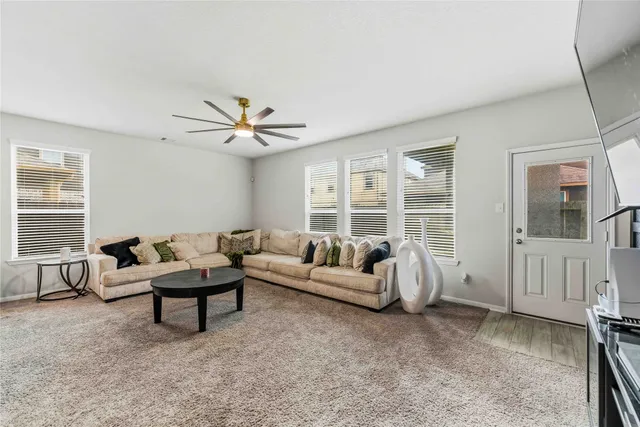 a living room with furniture and windows
