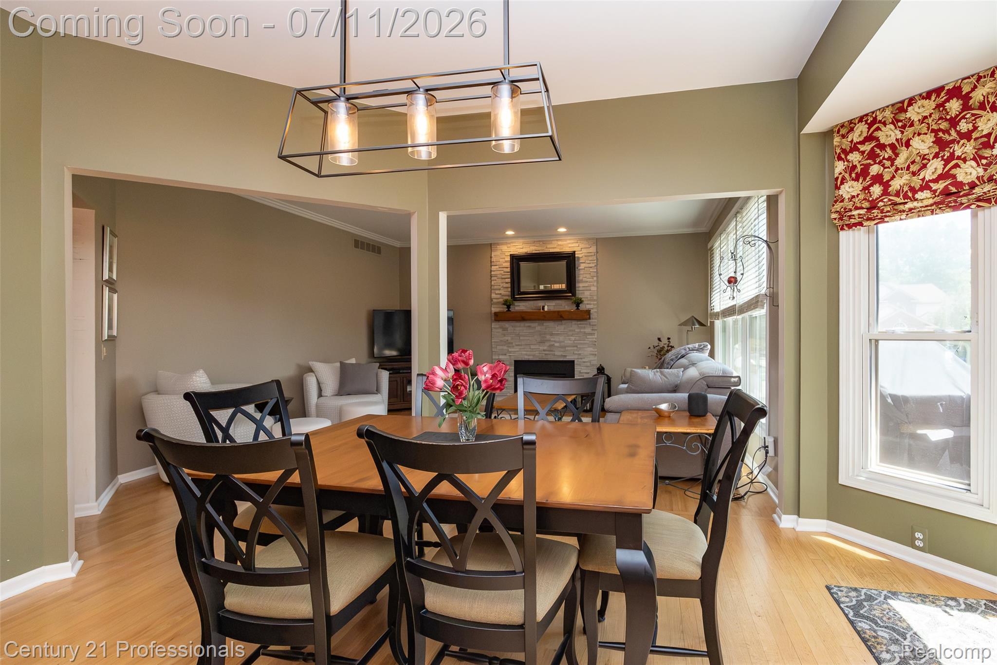 689 Woodfield Way Rochester, MI 48307 - Photo 15 of 61 Expansive dining area featuring wood-finish flooring, a modern linear chandelier, and a bay window