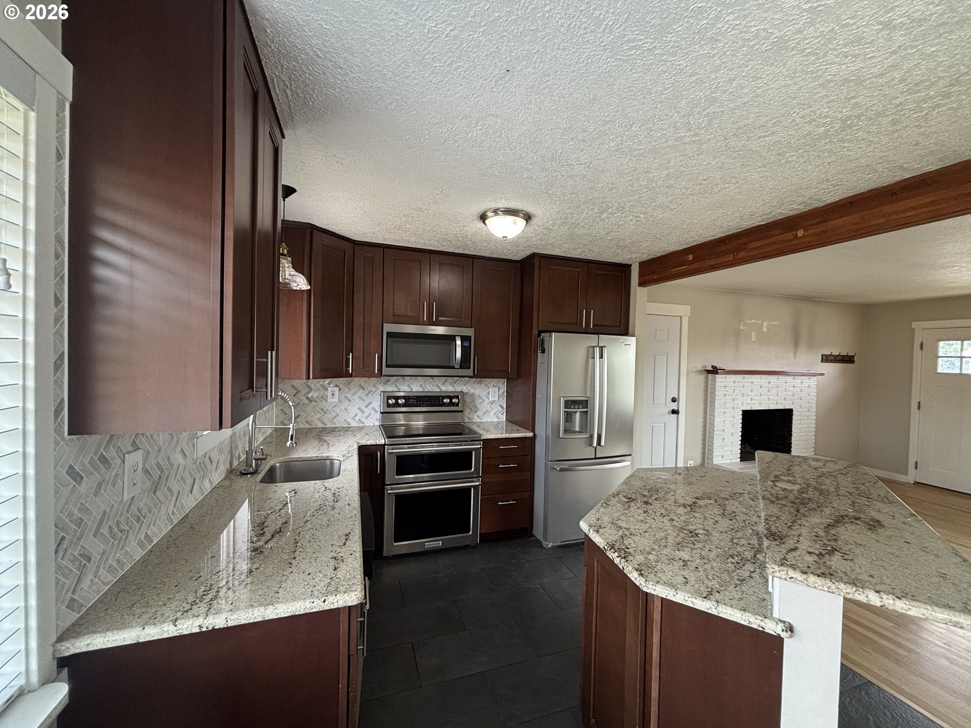 924 Southwest 33rd Street Pendleton, OR 97801 - Photo 5 of 27 a kitchen with stainless steel appliances granite countertop a sink stove and refrigerator