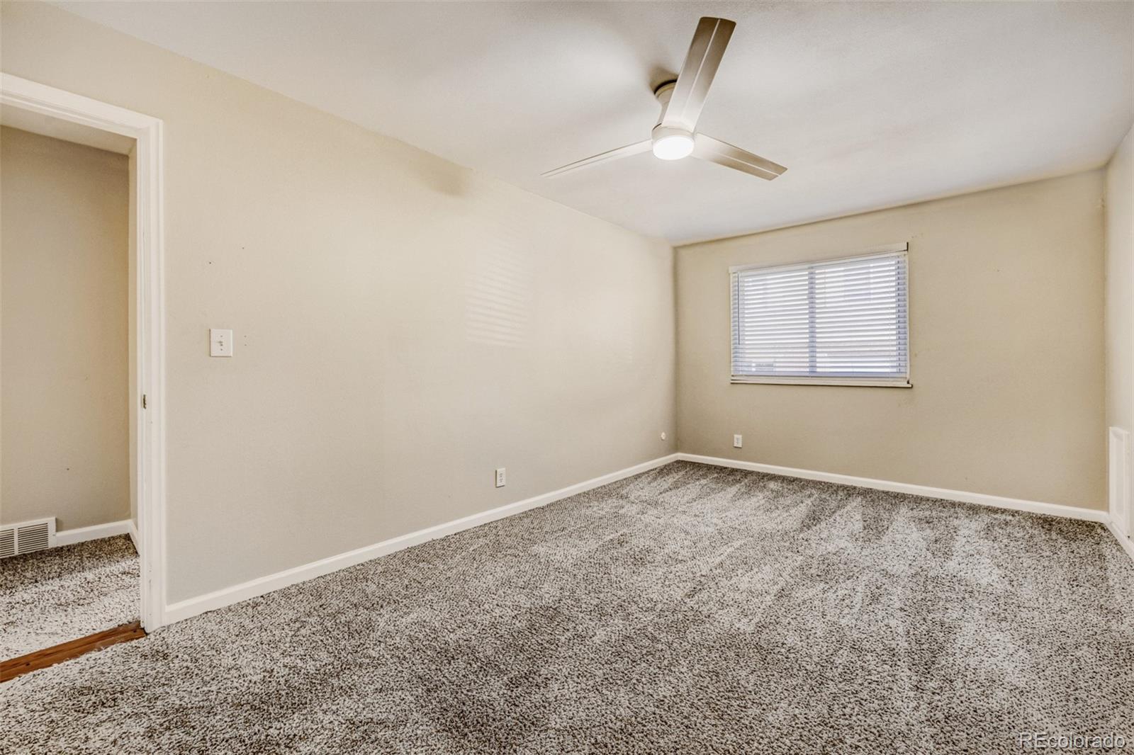 9787 Lane Street Thornton, CO 80260 - Photo 12 of 29 an empty room with a empty space and windows