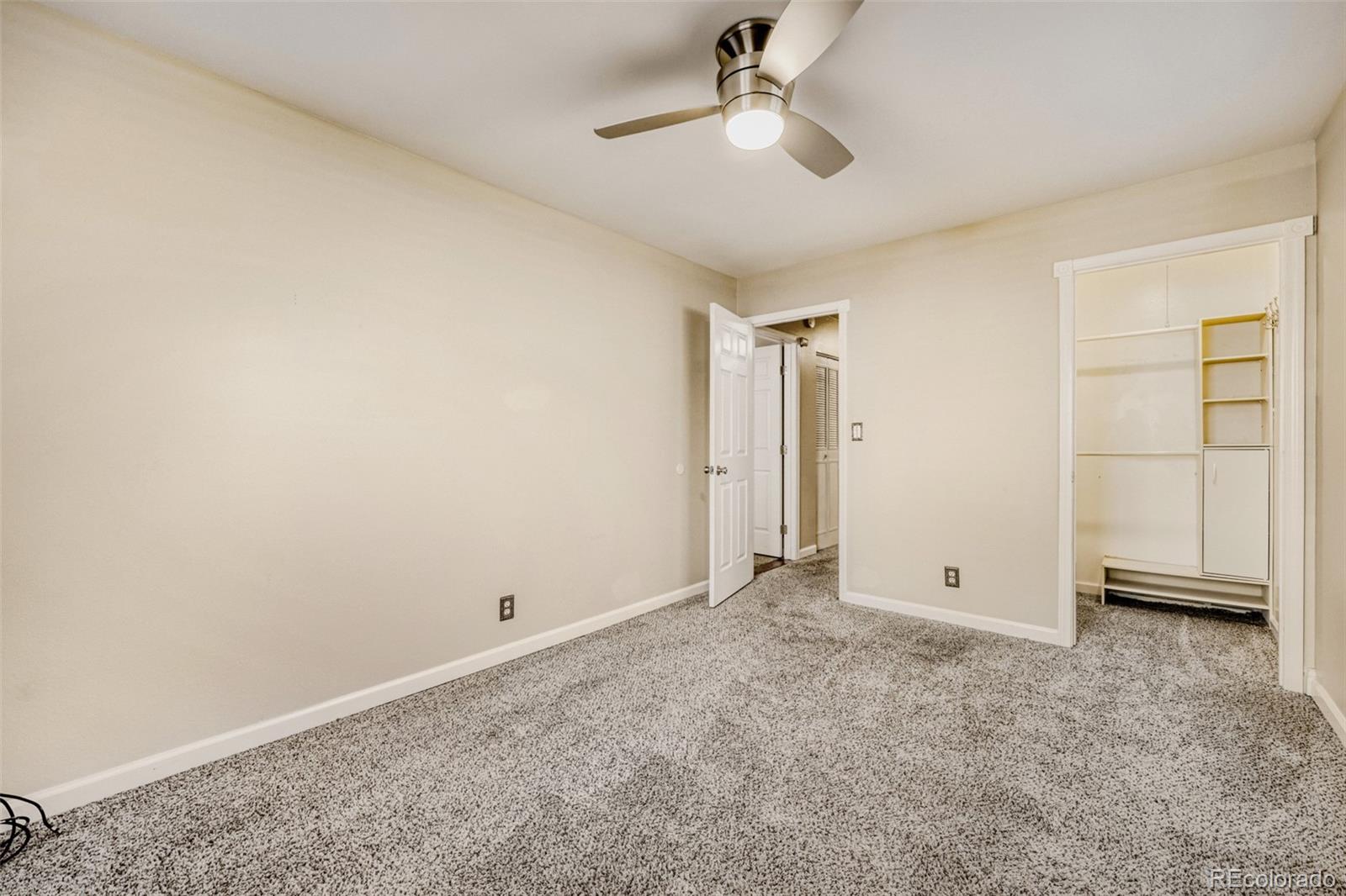 9787 Lane Street Thornton, CO 80260 - Photo 14 of 29 an empty room with closet and windows