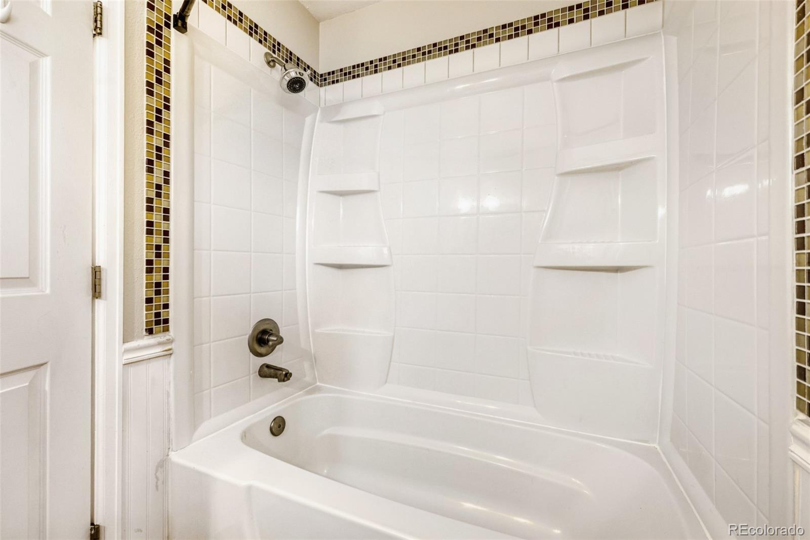 9787 Lane Street Thornton, CO 80260 - Photo 16 of 29 a bathroom with a shower and a bath tub