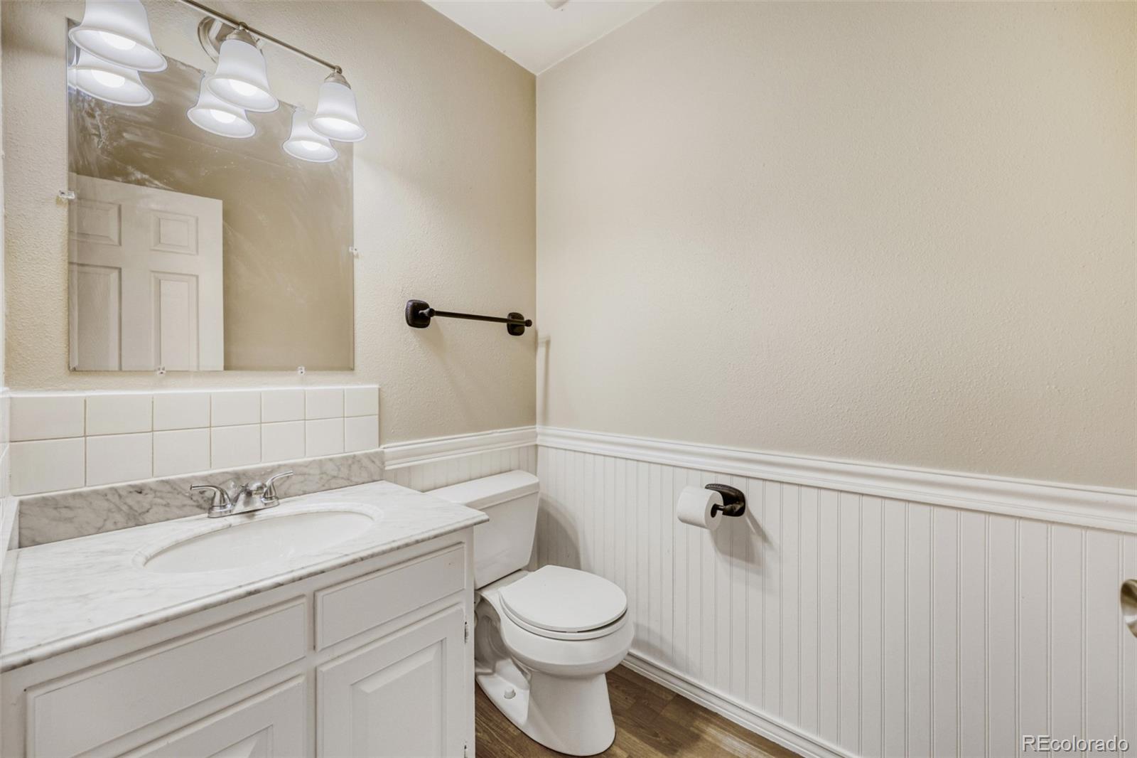 9787 Lane Street Thornton, CO 80260 - Photo 17 of 29 a bathroom with a sink a toilet and shower