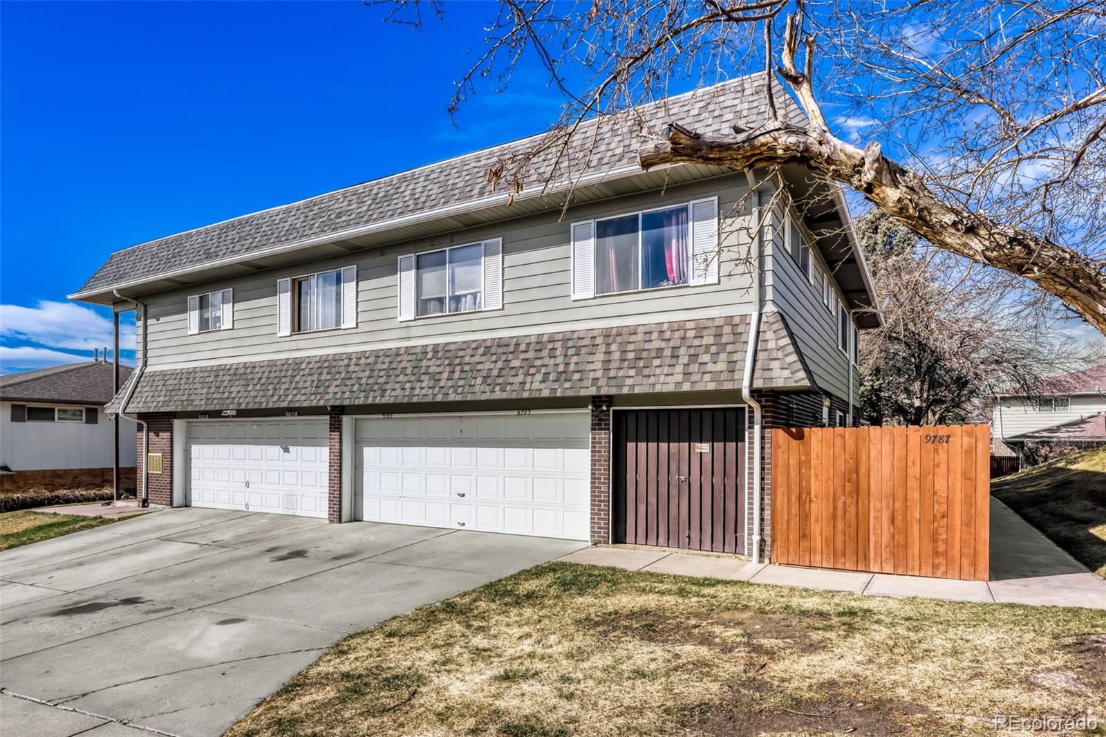 9787 Lane Street Thornton, CO 80260 - Photo 25 of 29 a front view of a house with a yard