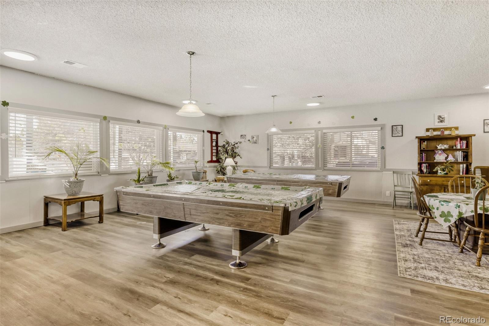 9787 Lane Street Thornton, CO 80260 - Photo 28 of 29 a room with lots of furniture and a wooden floor