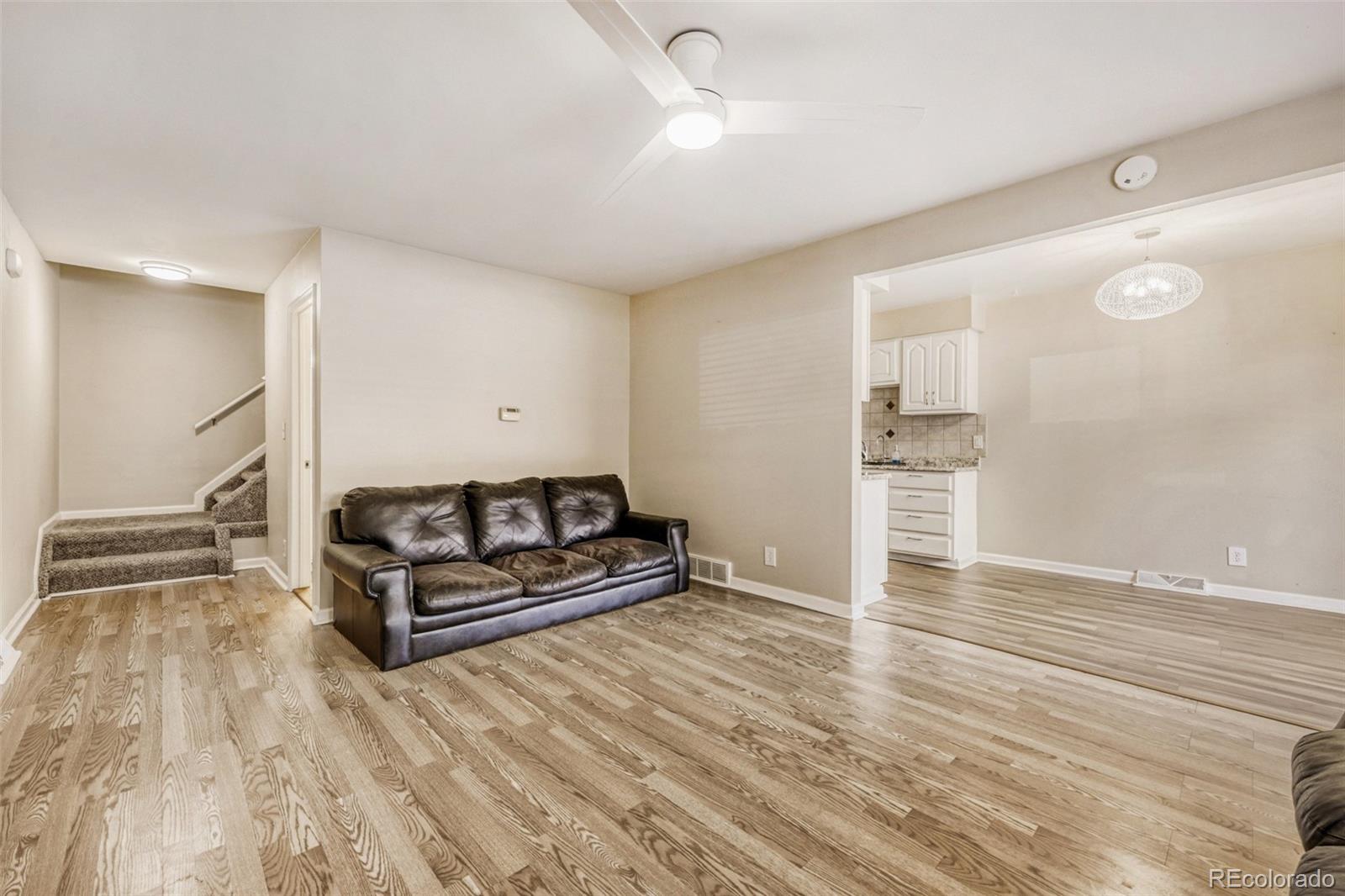 9787 Lane Street Thornton, CO 80260 - Photo 3 of 29 wooden floor with white walls and window