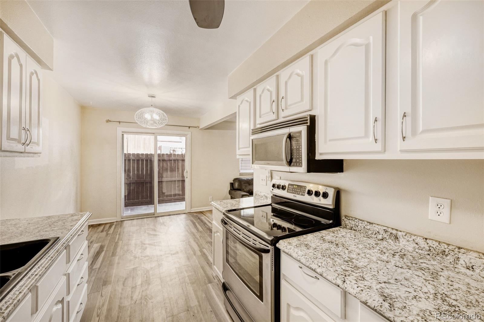 9787 Lane Street Thornton, CO 80260 - Photo 8 of 29 a kitchen with a stove and a sink