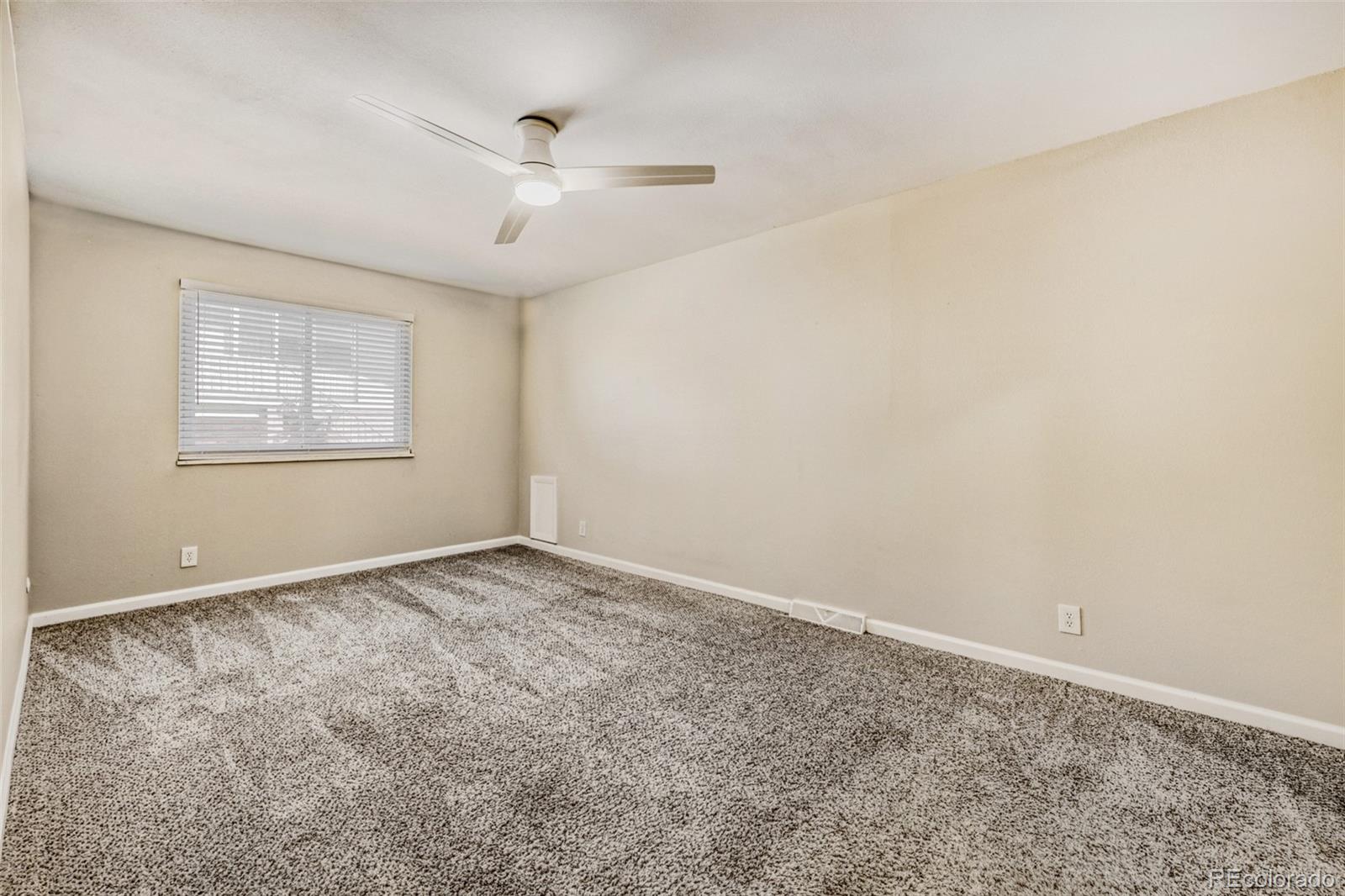 9787 Lane Street Thornton, CO 80260 - Photo 10 of 29 an empty room with windows and fan