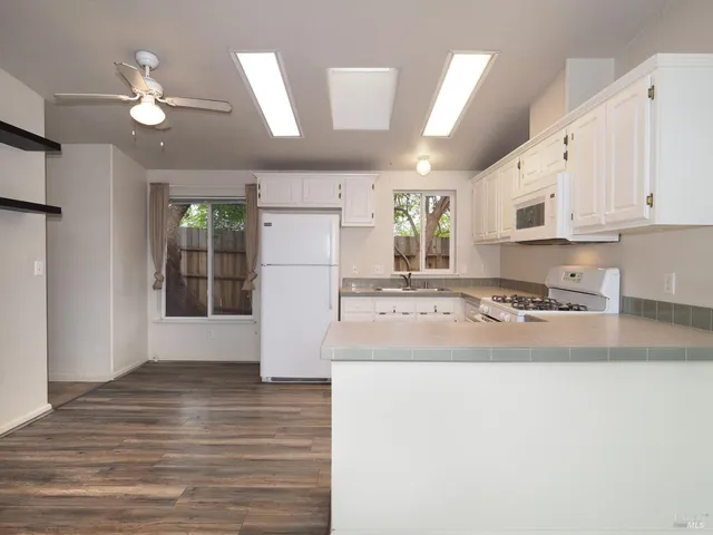 a view of kitchen with cabinets and wooden floor