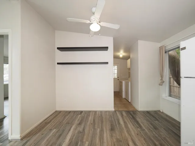 a view of an empty room with wooden floor