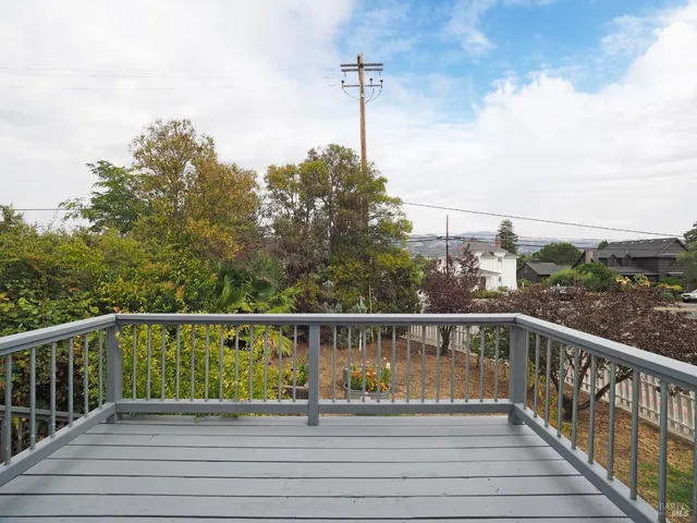 a view of a balcony with wooden floor