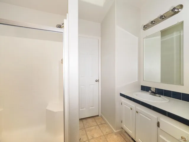 a bathroom with a double vanity sink and a mirror