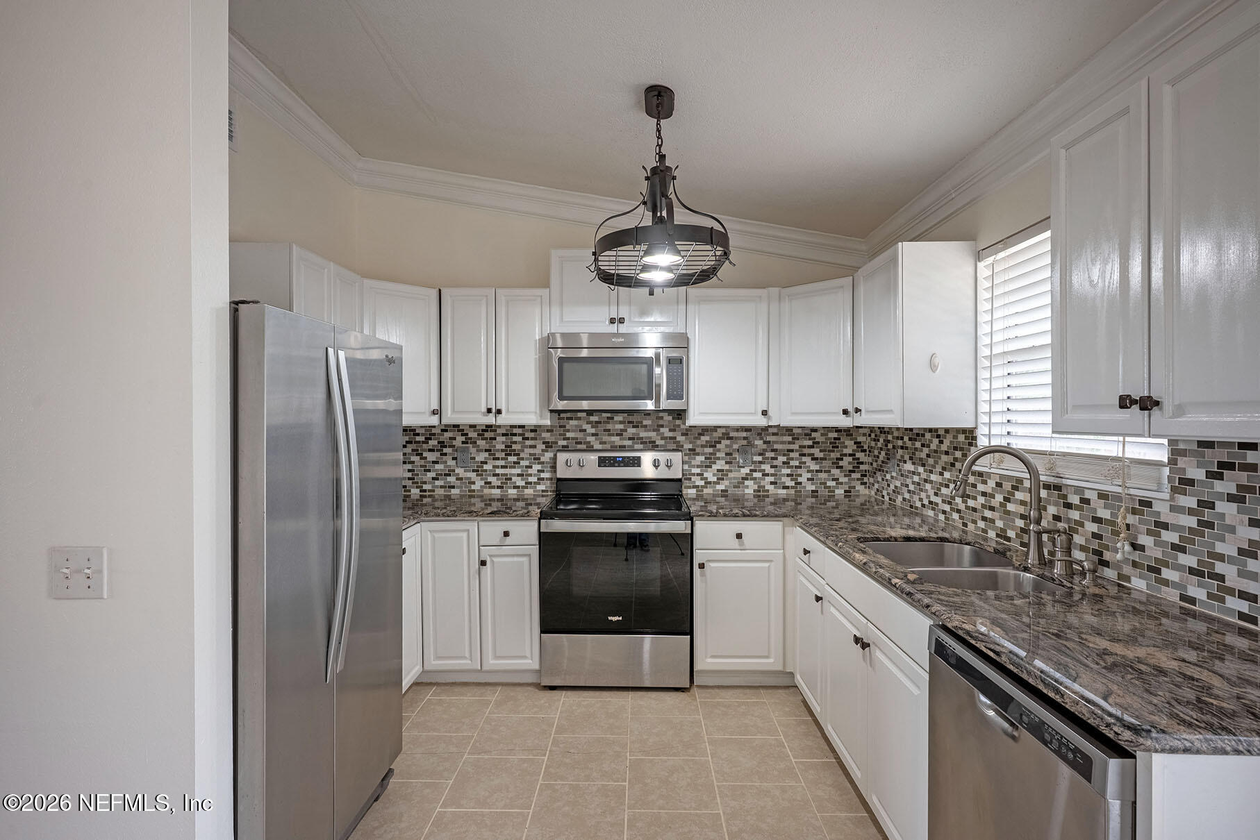 430 Southwest Jasmine Avenue Keystone Heights, FL 32656 - Photo 10 of 37 a kitchen with stainless steel appliances granite countertop a refrigerator and a stove top oven