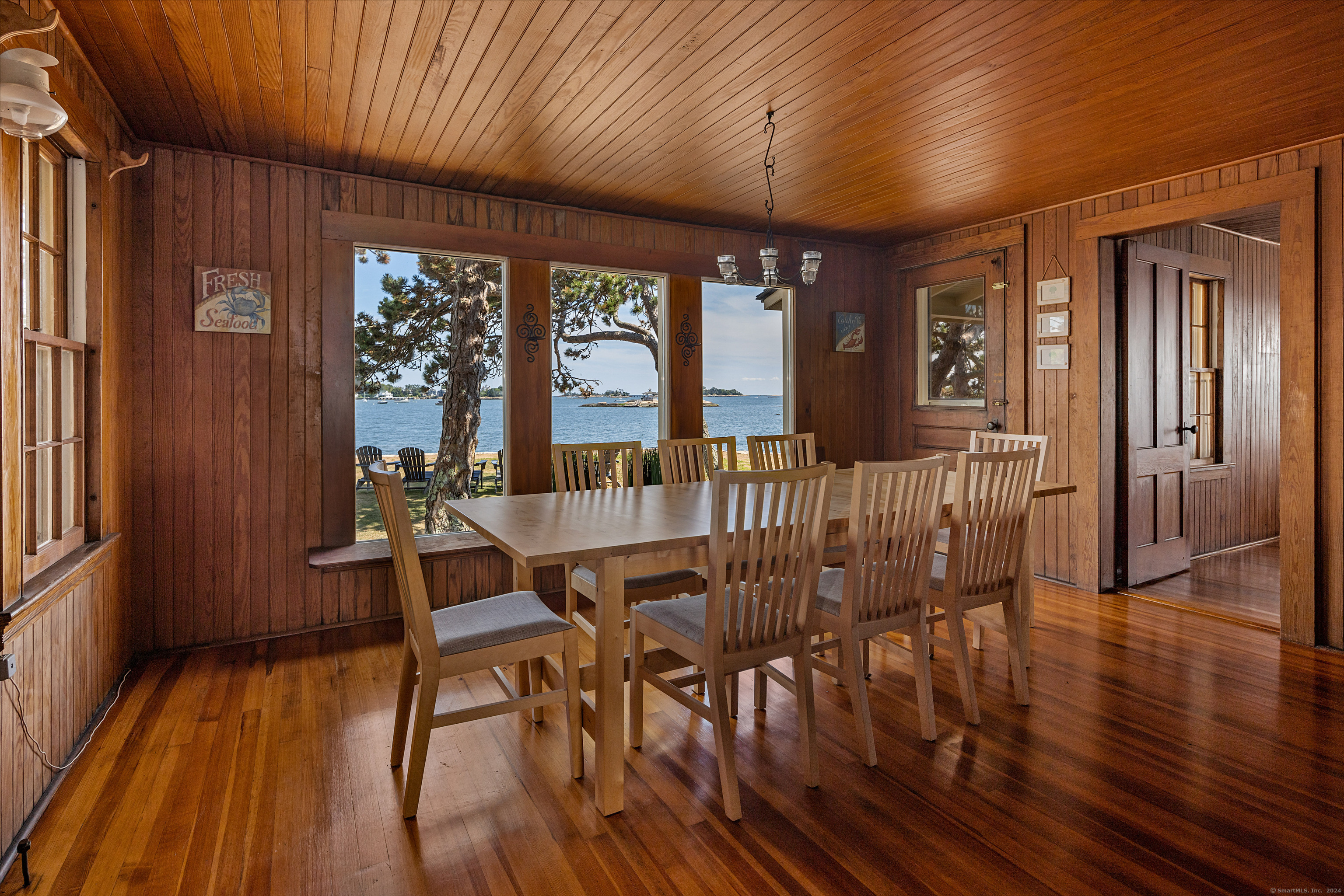 Belden Island Branford, CT 06405 - Photo 29 of 40 a view of a dining room with furniture window and wooden floor
