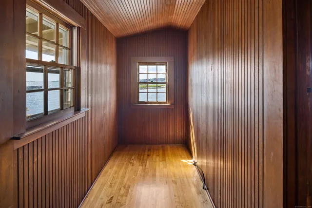 a bedroom with a bed and a wooden floor