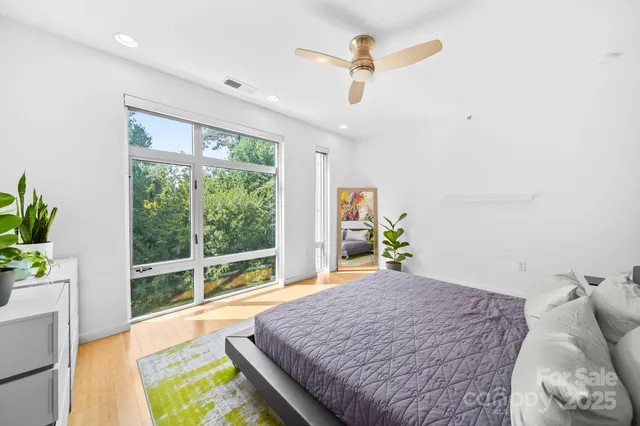 a bed sitting in a bedroom next to a window