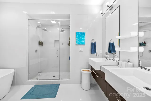 a bathroom with a double vanity sink toilet and shower