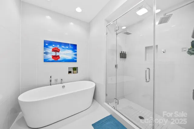 a white bath tub sitting next to a bathroom