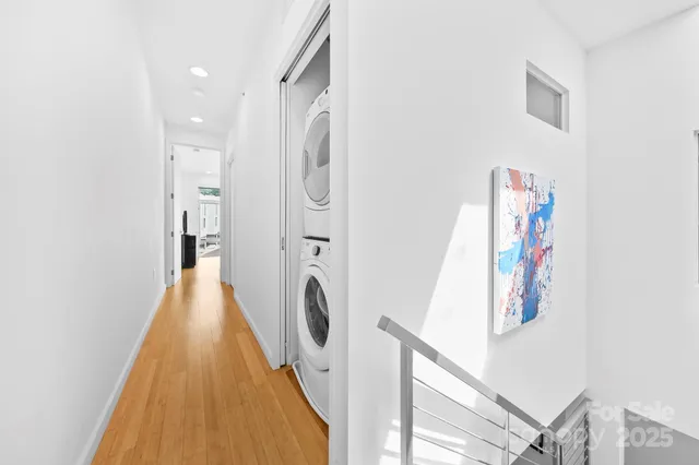 a view of a hallway with washer and dryer