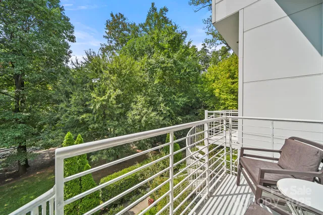 a view of balcony with wooden floor and outdoor seating