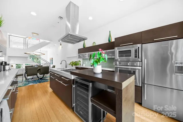 a kitchen with stainless steel appliances granite countertop a sink a stove and a refrigerator
