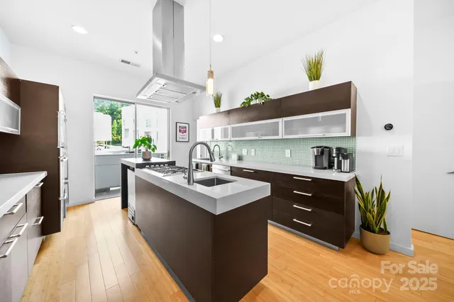 a kitchen with stainless steel appliances a sink stove and refrigerator