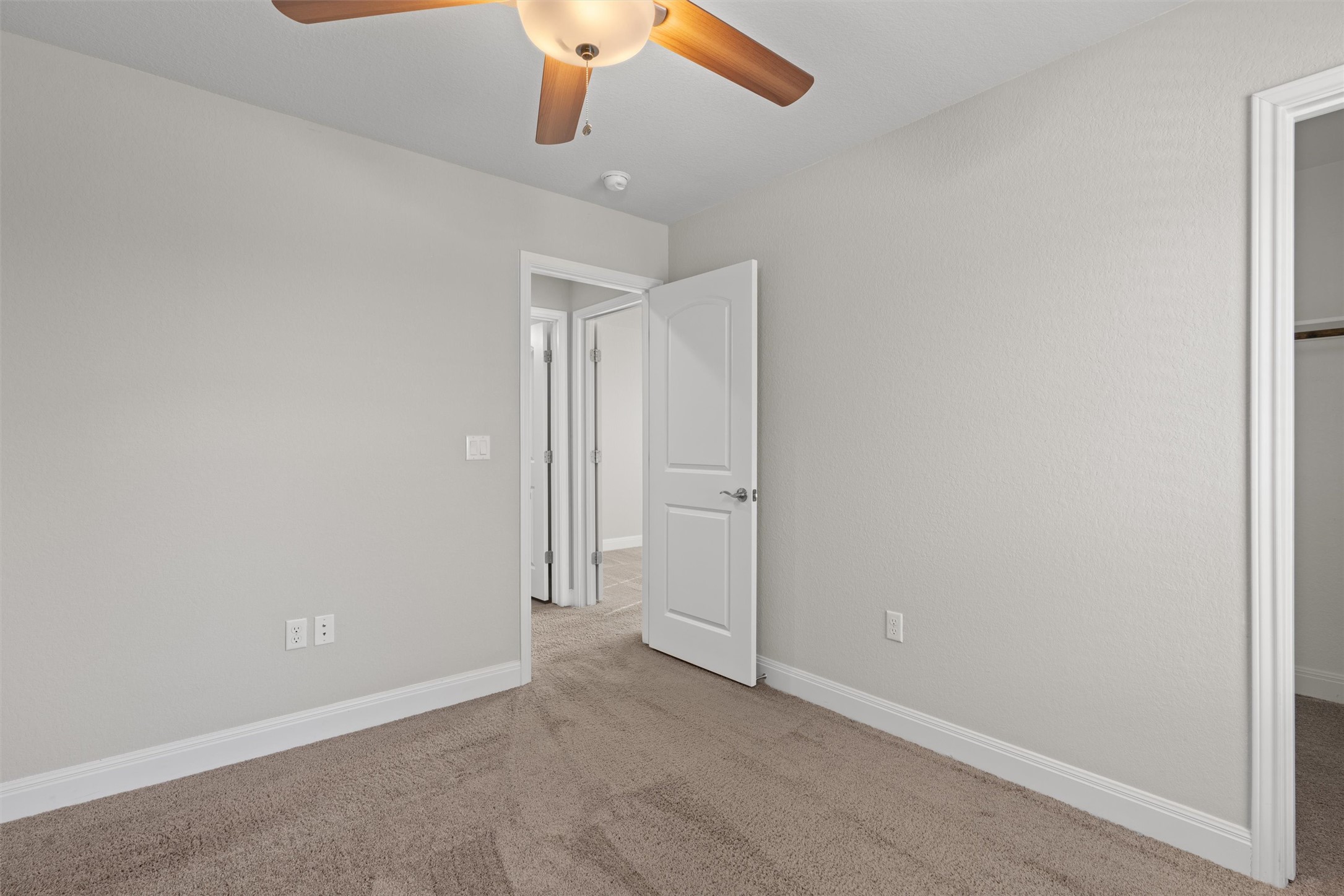 10502 Turnbull Loop, Unit 41 Austin, TX 78717 - Photo 20 of 35 Unfurnished bedroom with a walk in closet, carpet floors, and a ceiling fan