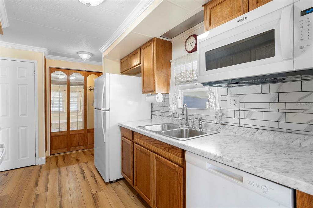 105 Florence Boulevard DeBary, FL 32713 - Photo 5 of 31 a kitchen with stainless steel appliances granite countertop a sink and a microwave