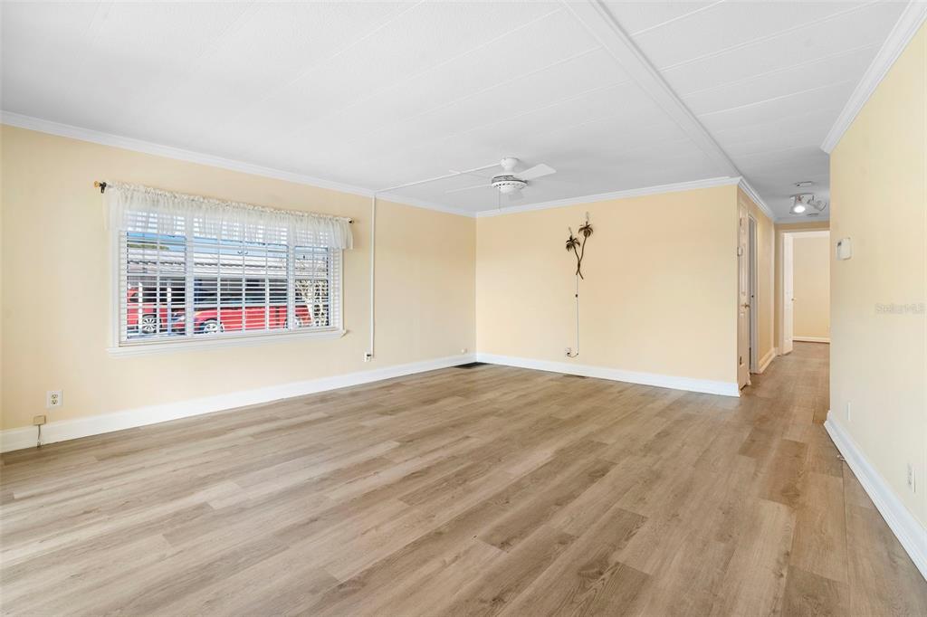 105 Florence Boulevard DeBary, FL 32713 - Photo 7 of 31 a view of empty room with wooden floor and fan