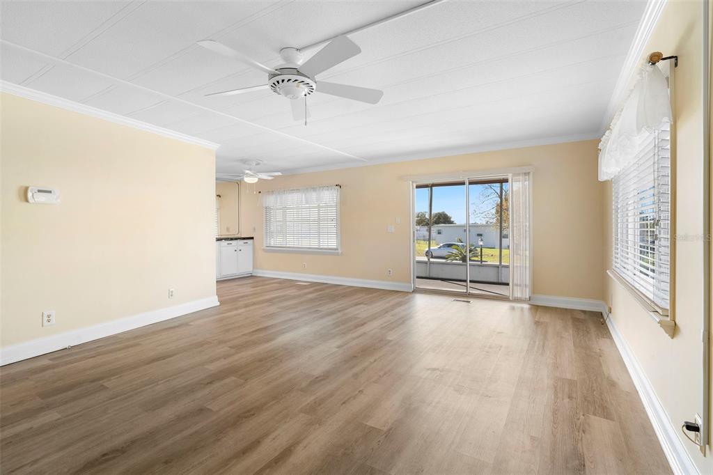 105 Florence Boulevard DeBary, FL 32713 - Photo 8 of 31 a view of a livingroom with wooden floor and a ceiling fan