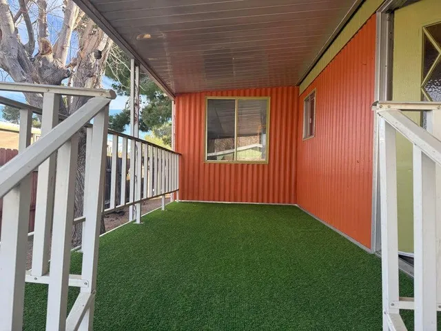 a view of an house with backyard and porch