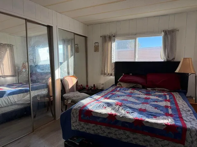 a bedroom with a bed a lamp and window