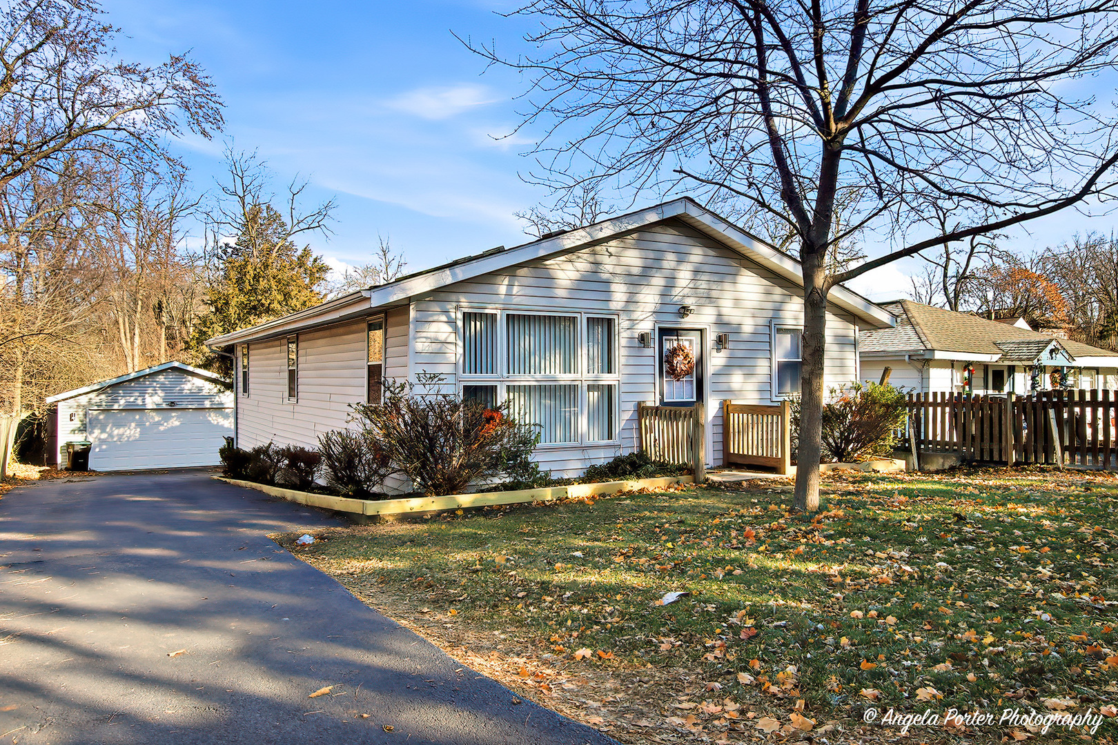 24676 West Clinton Avenue Round Lake, IL 60073 - Photo 1 of 28 a front view of house with yard and trees around