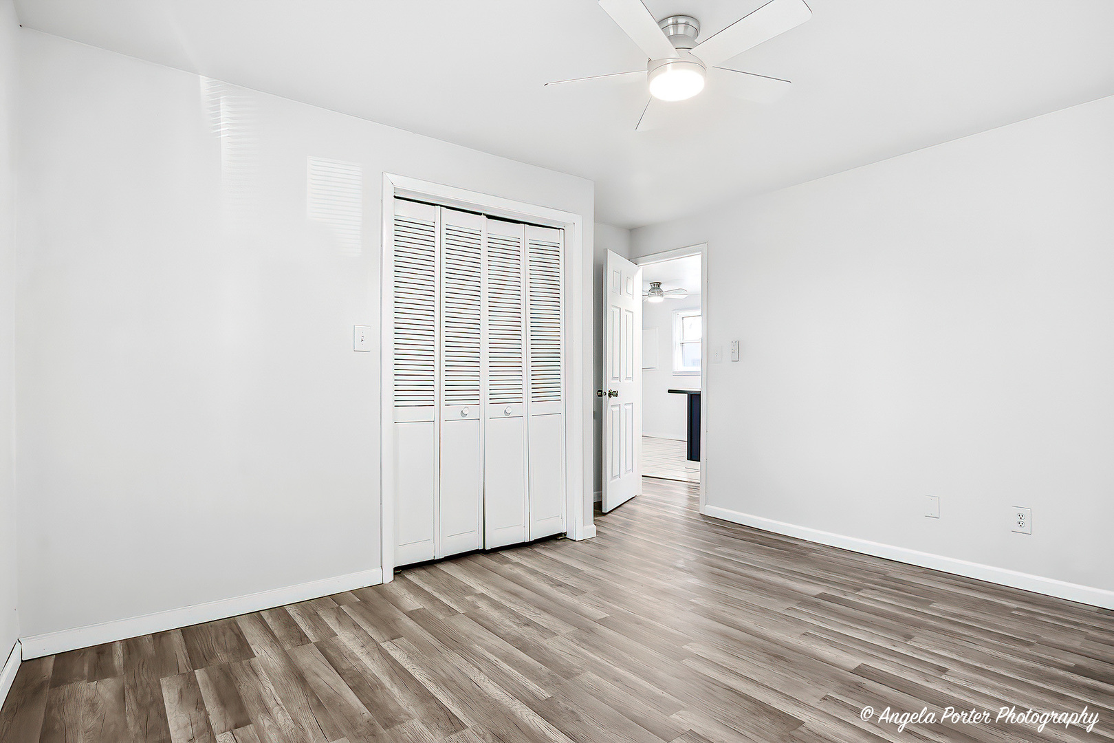 24676 West Clinton Avenue Round Lake, IL 60073 - Photo 13 of 28 an empty room with wooden floor and windows