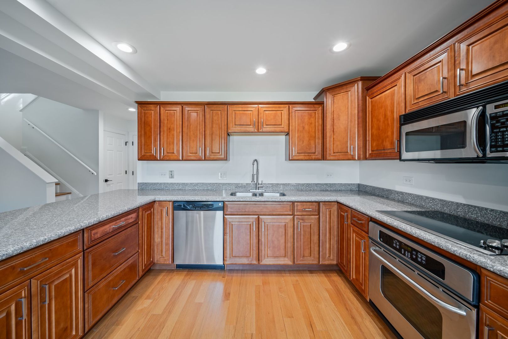 613 Dunham Road, Unit 613 Gurnee, IL 60031 - Photo 6 of 27 a kitchen with stainless steel appliances granite countertop wooden cabinets a sink dishwasher a stove and a refrigerator