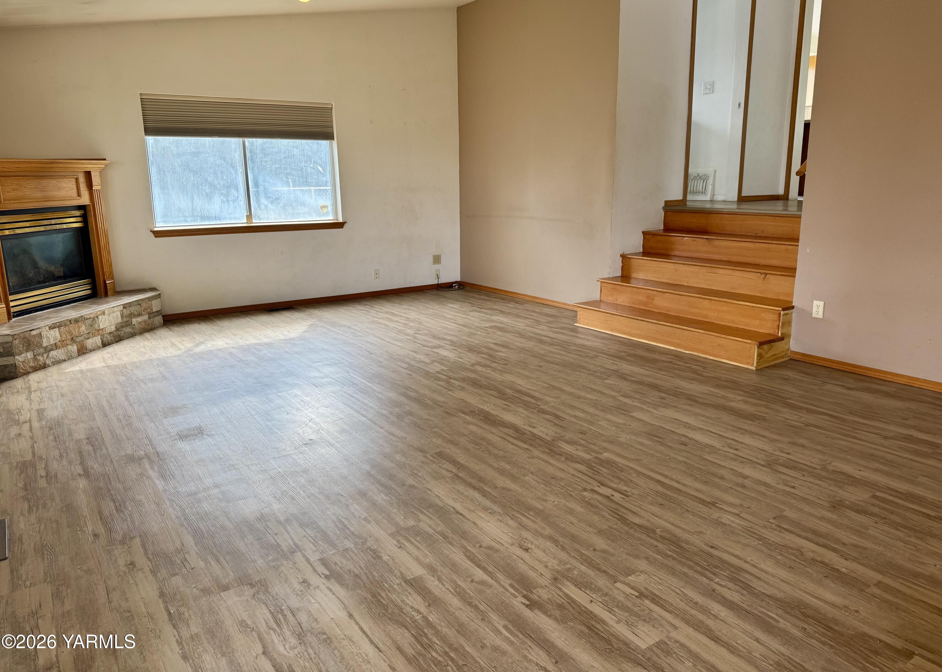 7801 Campbell Road, Unit 1 Toppenish, WA 98948 - Photo 10 of 46 a view of an empty room with wooden floor and a window