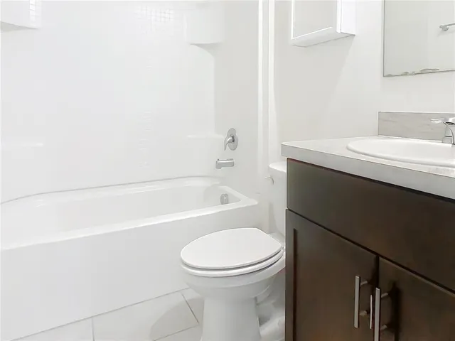 a bathroom with a sink a toilet and bathtub