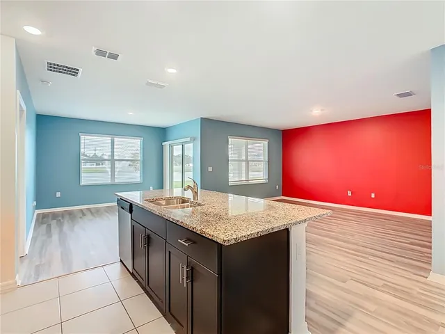 a kitchen with a sink microwave and window