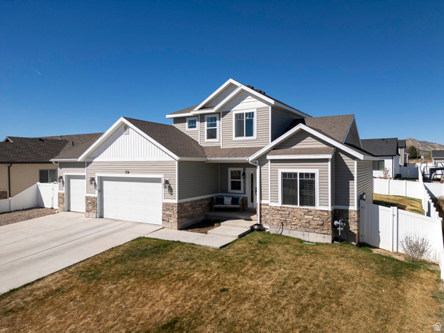 836 South 250 West Vernal, UT 84078 - Photo 56 of 56 Craftsman-style home featuring stone siding, an attached garage, concrete driveway, and a gate