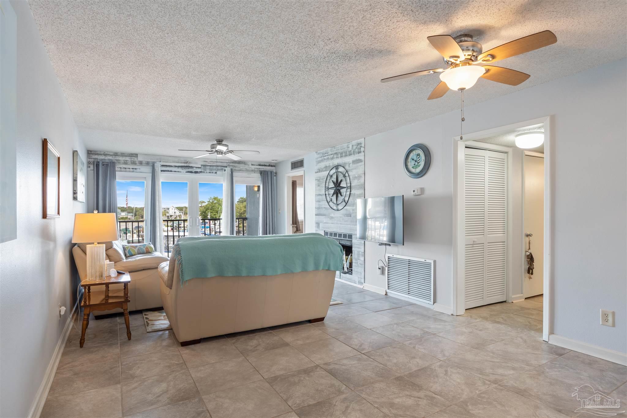 14100 River Road, Unit 228B Pensacola, FL 32507 - Photo 6 of 41 a living room with furniture and a large window