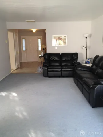 a living room with furniture and a mirror