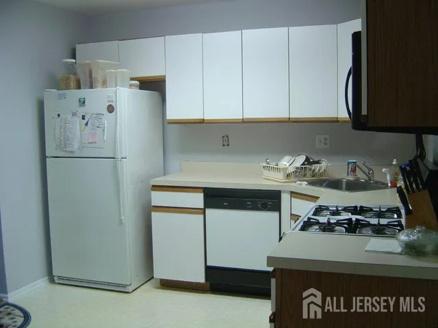 a kitchen with a refrigerator and a stove