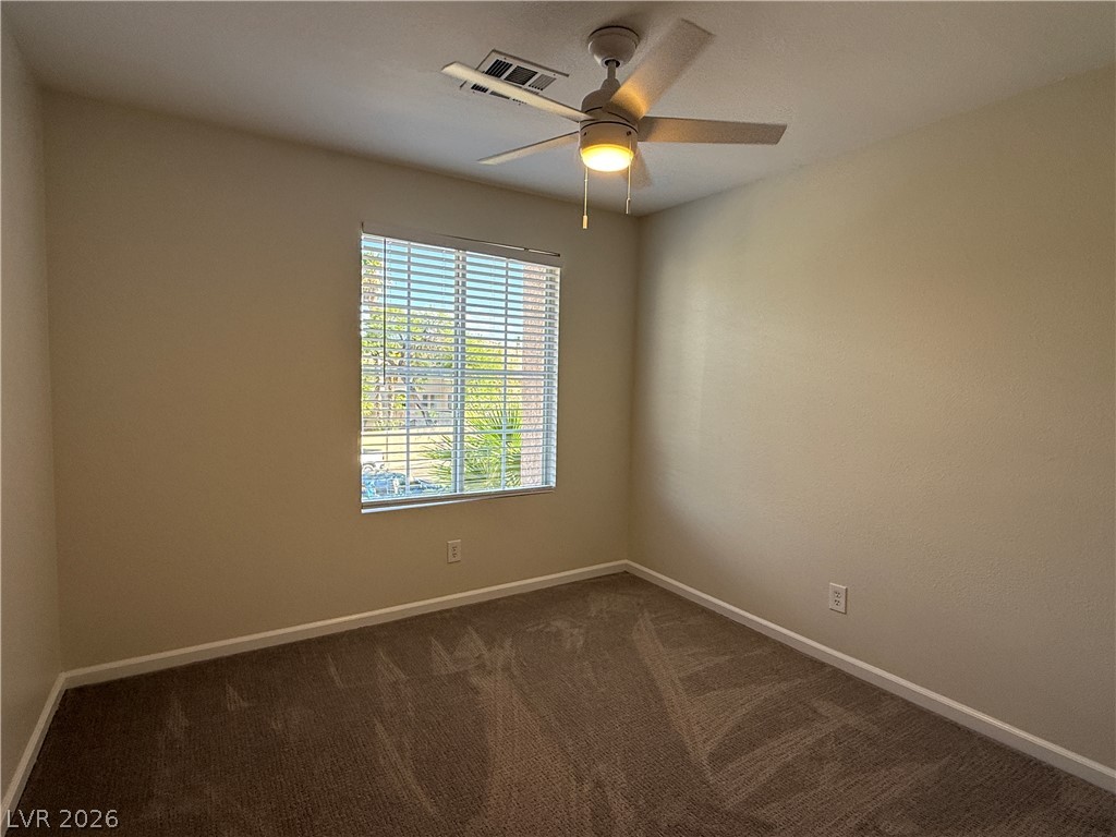 1908 Thunder Ridge Circle Henderson, NV 89012 - Photo 20 of 28 A well-lit room awaits your personal touch, complete with ceiling fan for optimal comfort.