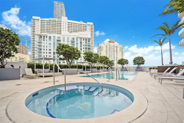 a view of a swimming pool with outdoor seating