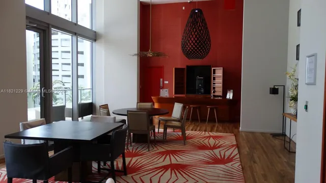 a living room with furniture a window and a dining table