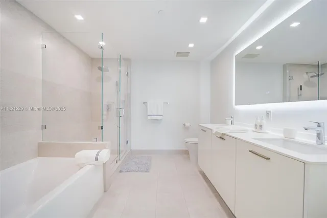 a bathroom with a tub a sink and mirror
