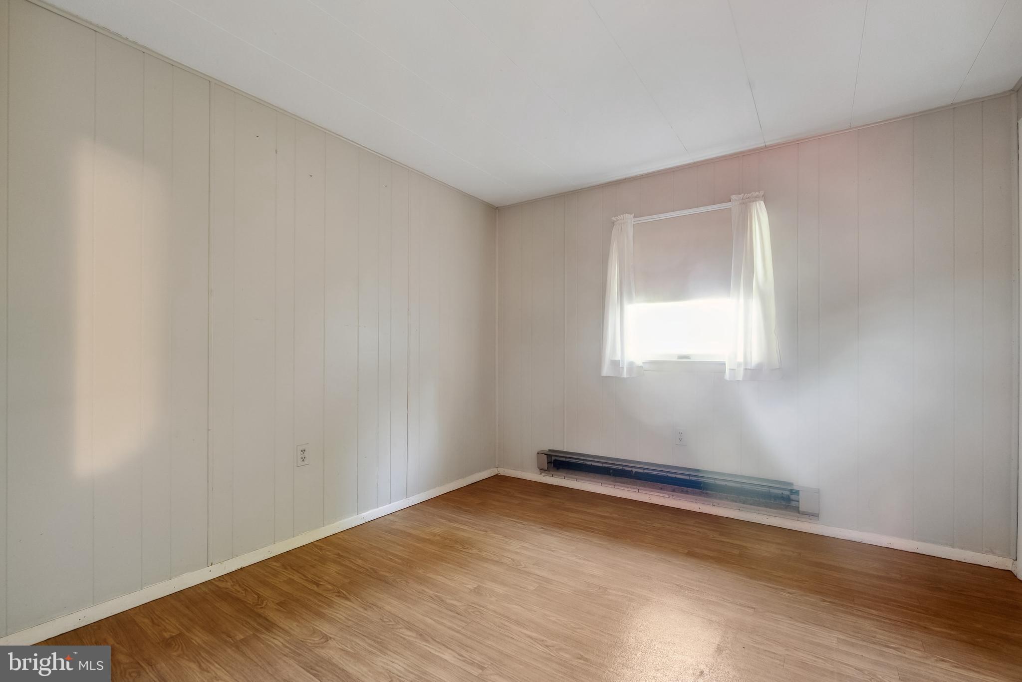 1106 Round Top Road Chestertown, MD 21620 - Photo 11 of 27 a view of an empty room with wooden floor and a window